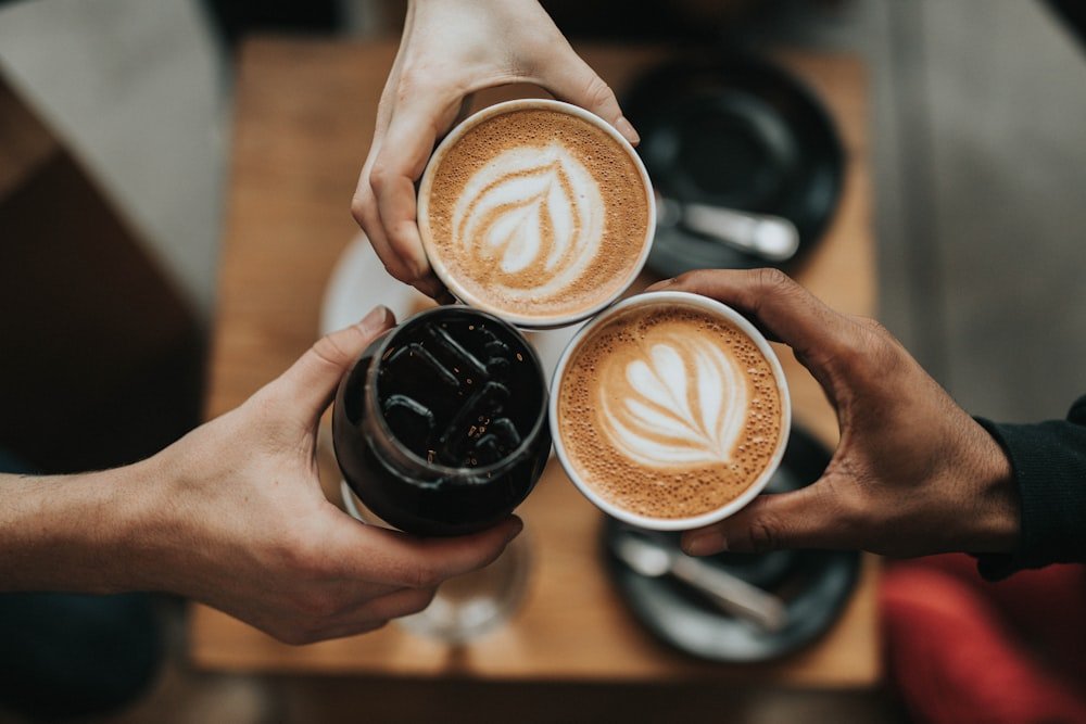 Two lattes raised together